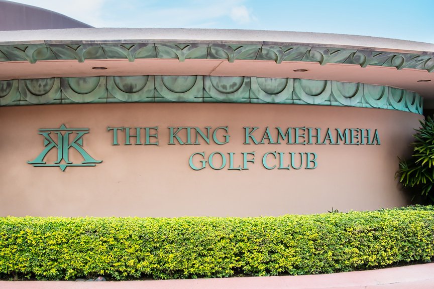 The King Kamehameha Golf Club sign in verdigris letters under a patterned copper fascia